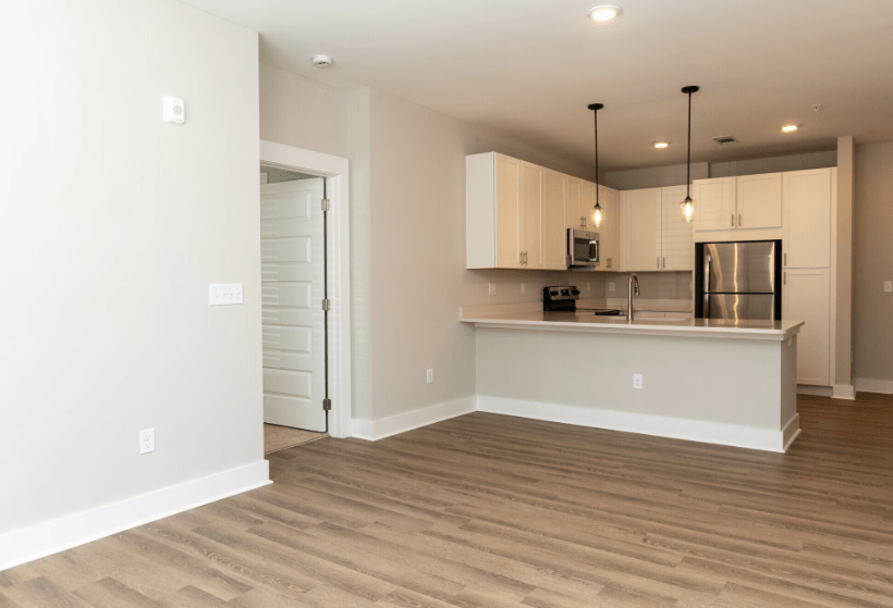 A kitchen with a white countertop and a white fridge.