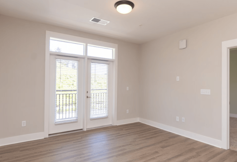 A room with a sliding door and a window.