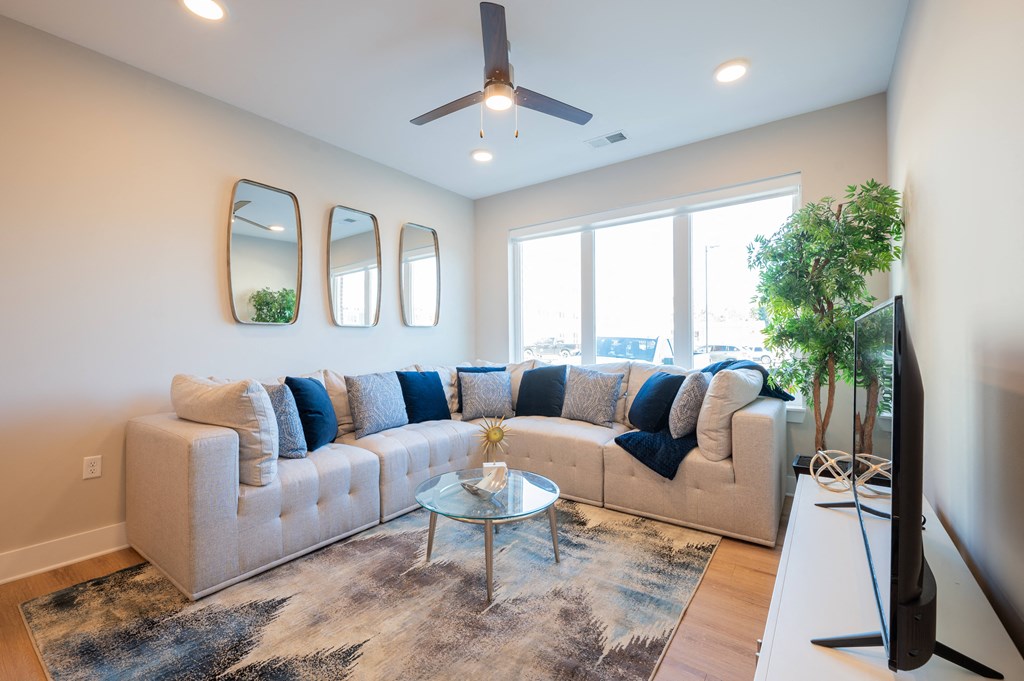 a living room with a couch and a table and a ceiling fan at Park View Greer, Greer, 29365