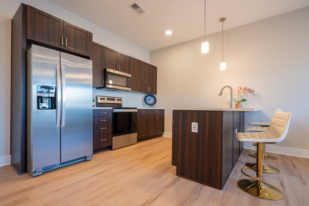 a kitchen with stainless steel appliances and a counter with a chair at Park View Greer, South Carolina