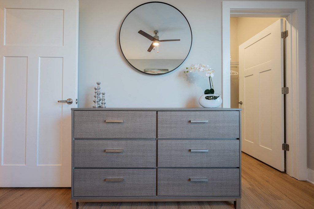 a bedroom with a dresser and a mirror on the wall at Park View Greer, Greer