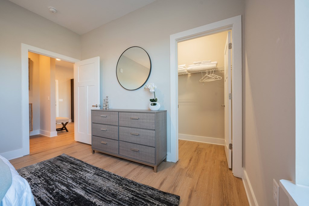 a bedroom with a dresser and a mirror and a closet at Park View Greer, Greer, 29365