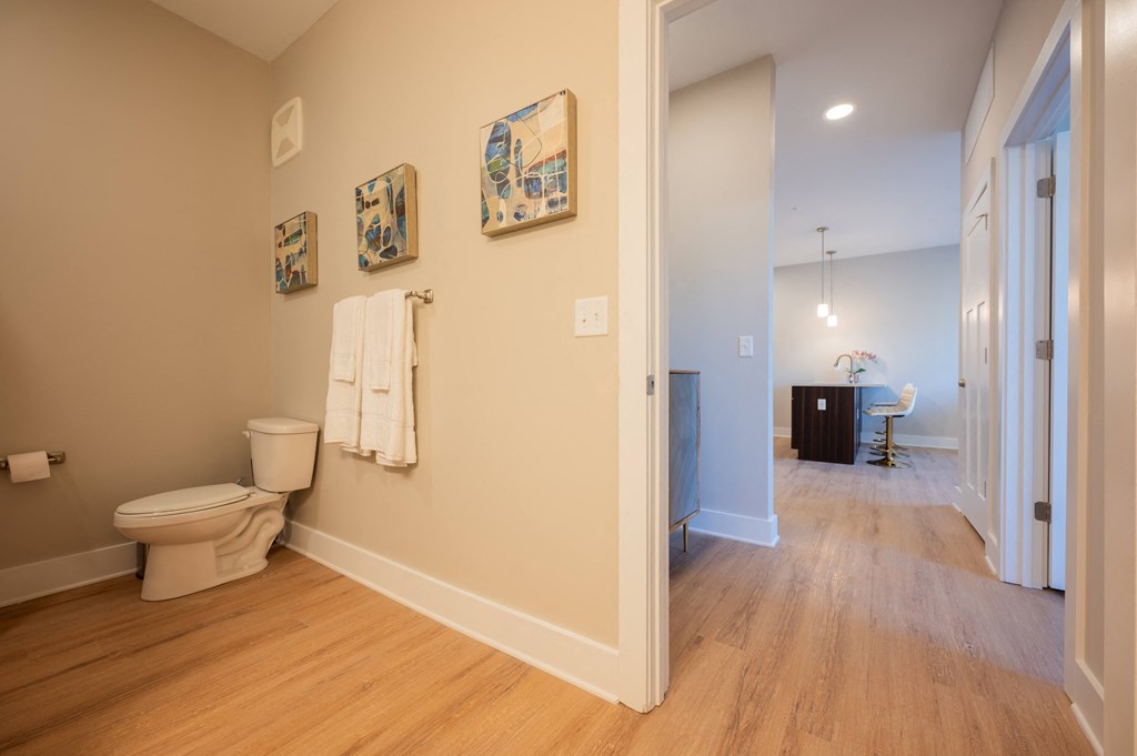 a living room with a toilet and a hallway with a bathroom at Park View Greer, Greer