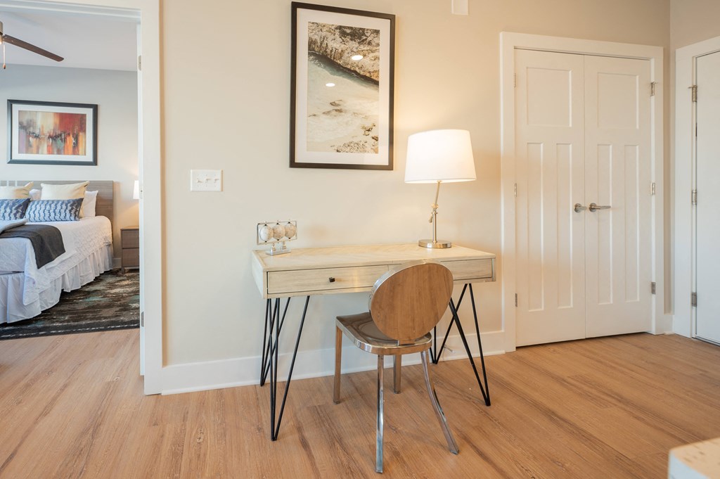 a desk with a chair and a lamp in a room with a bedroom at Park View Greer, Greer, SC