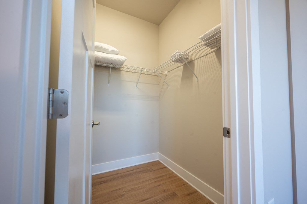 a walk in closet with a mirrored closet door and a wire rack at Park View Greer, Greer, South Carolina