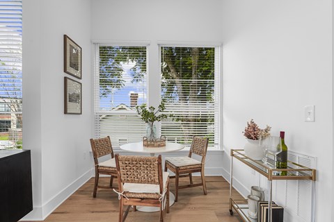 A dining room with a table set for four.