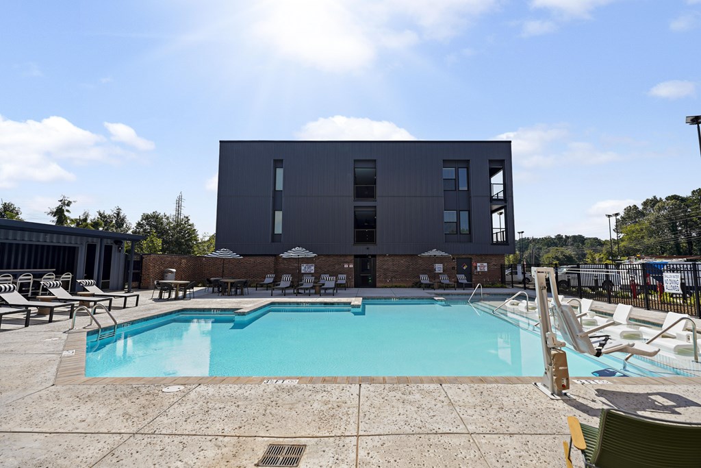 A large swimming pool in front of a modern building.