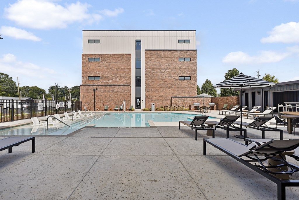 A pool area with a building in the background.