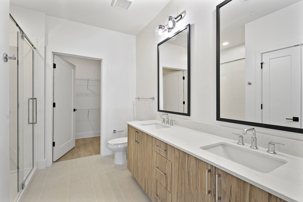 A bathroom with a sink, mirror, and toilet.