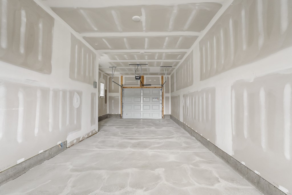 A long, empty hallway with a door at the end.