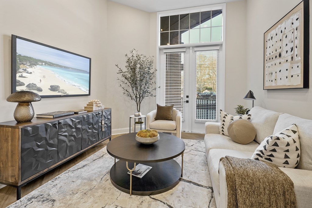 A living room with a flat screen TV displaying a beach scene.