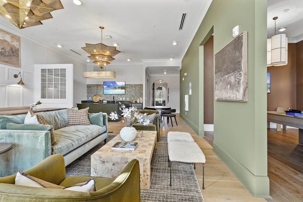 A modern living room with a green couch and a coffee table.