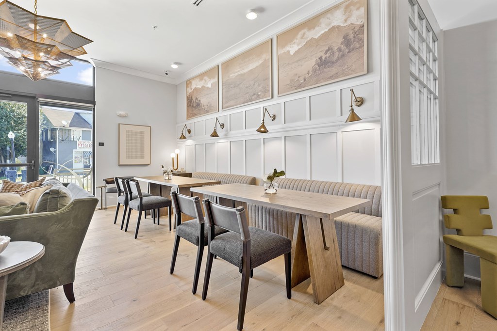 A dining room with a long table and chairs.