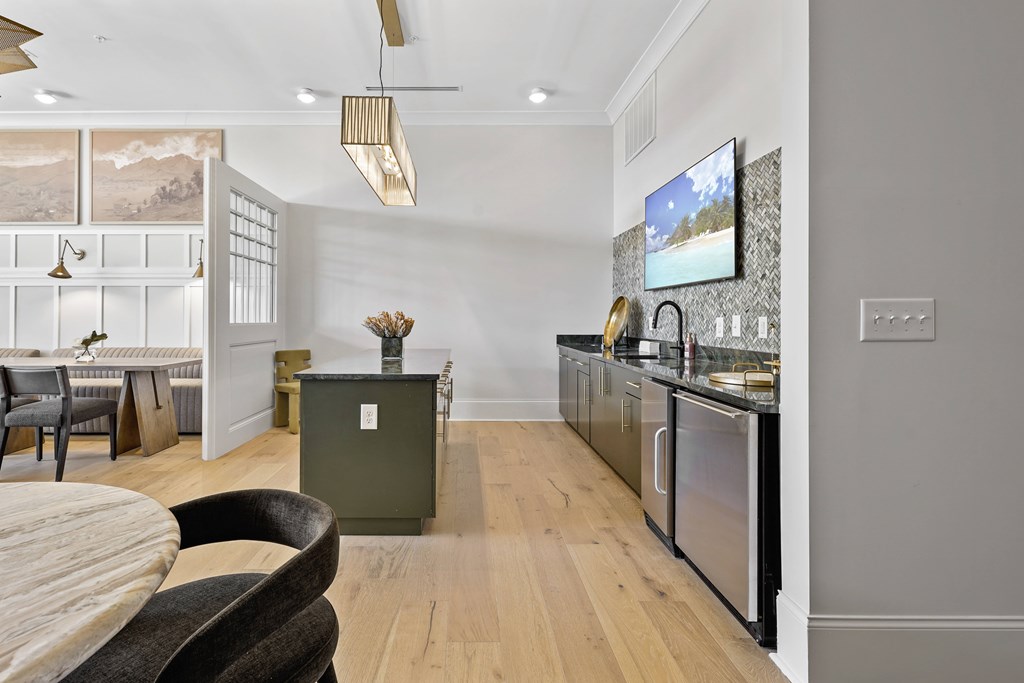 A modern kitchen with a wooden table and chairs.