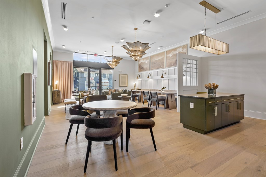 A modern dining room with a round table and chairs.