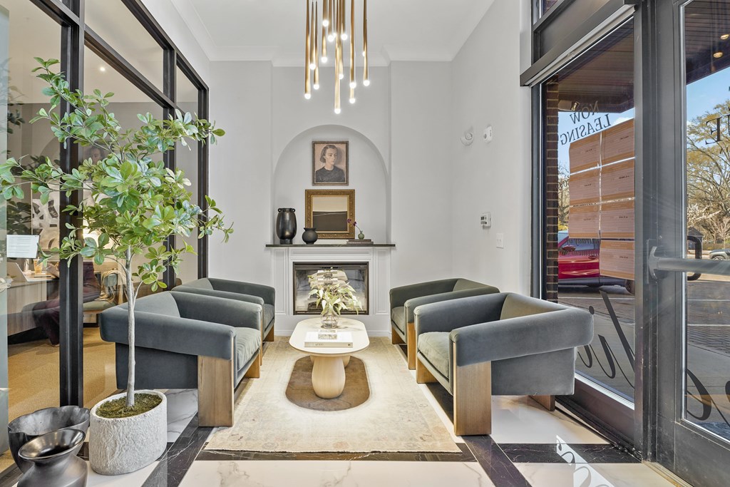 A living room with a grey couch and a fireplace.