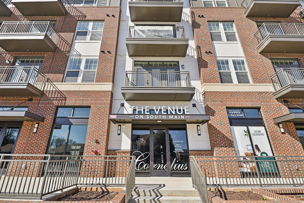 The Venue on South Main is a multi-story apartment building with balconies and a sign for Corrie Louise.