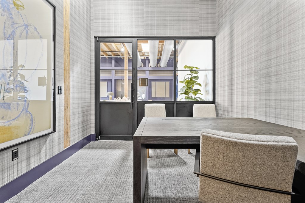 A conference room with a table and chairs.