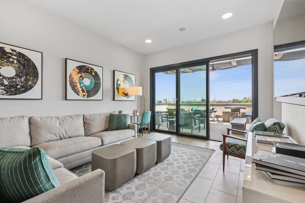 a living room with a couch and a table and a balcony