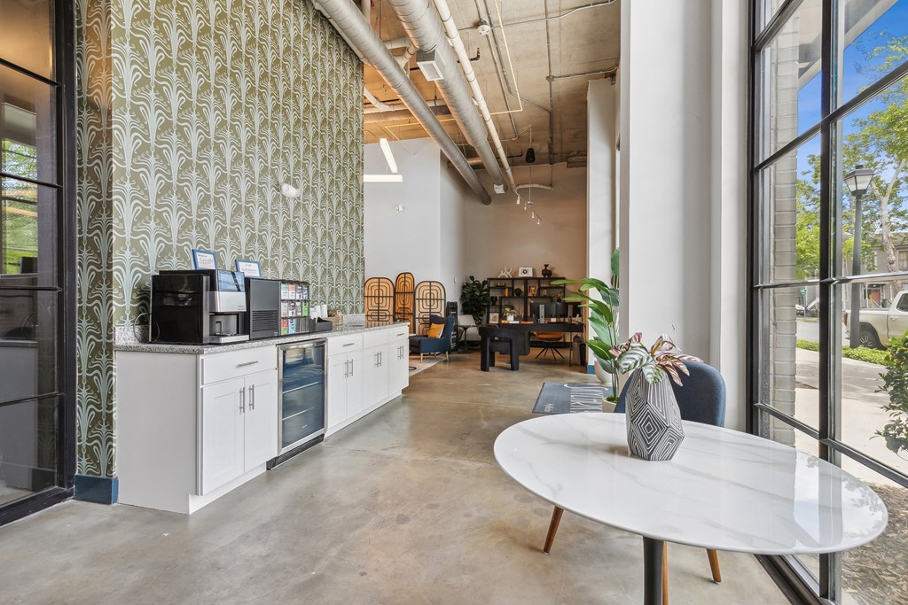 a living room with a kitchen and a table