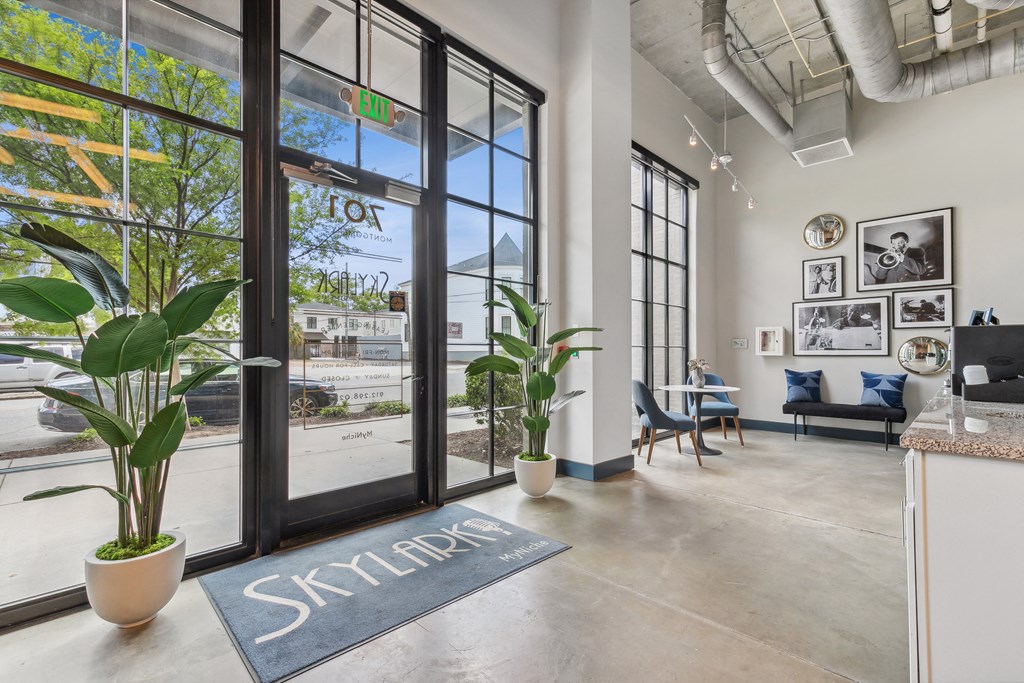 the lobby of a building with glass doors and a view of the street