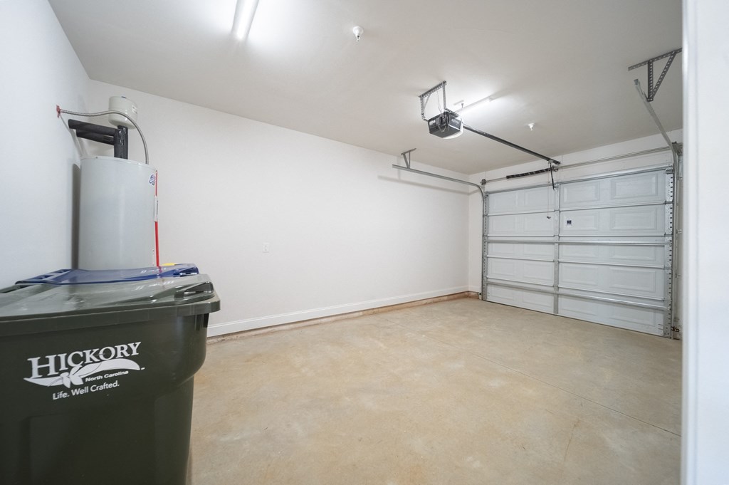 a room with white walls and a beige floor at Landon Green Artisan Cottages Apartments, Hickory, North Carolina