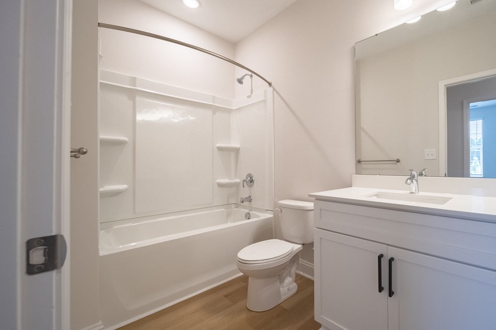 a bathroom with a bathtub toilet and sink at Landon Green Artisan Cottages Apartments, North Carolina