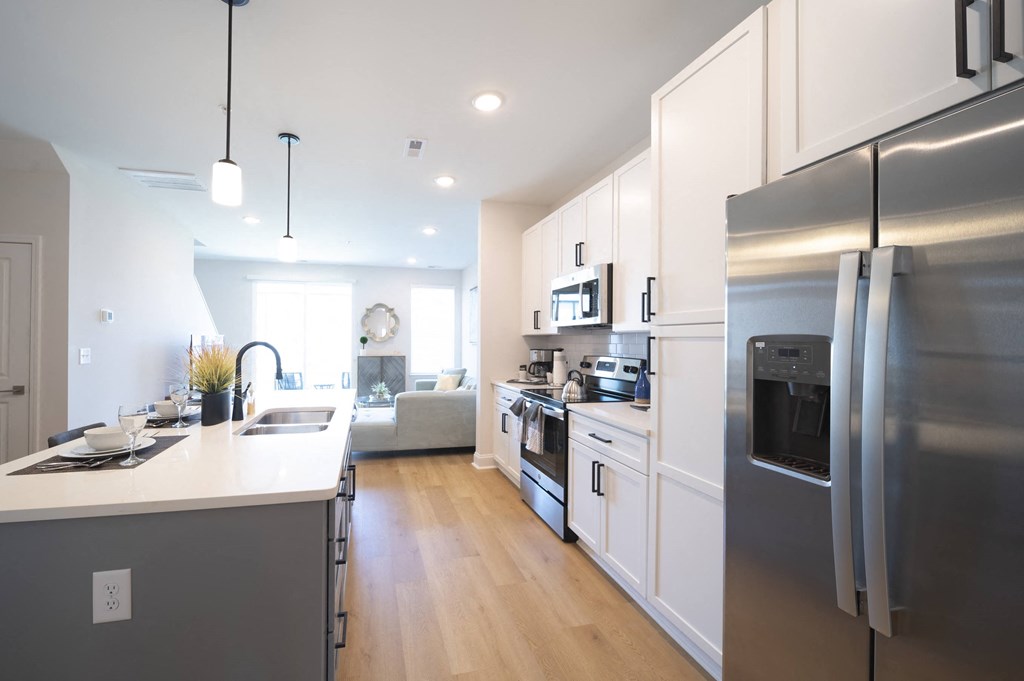 a kitchen with cabinets and stainless steel appliances at Landon Green Artisan Cottages Apartments, Hickory, NC, 28601