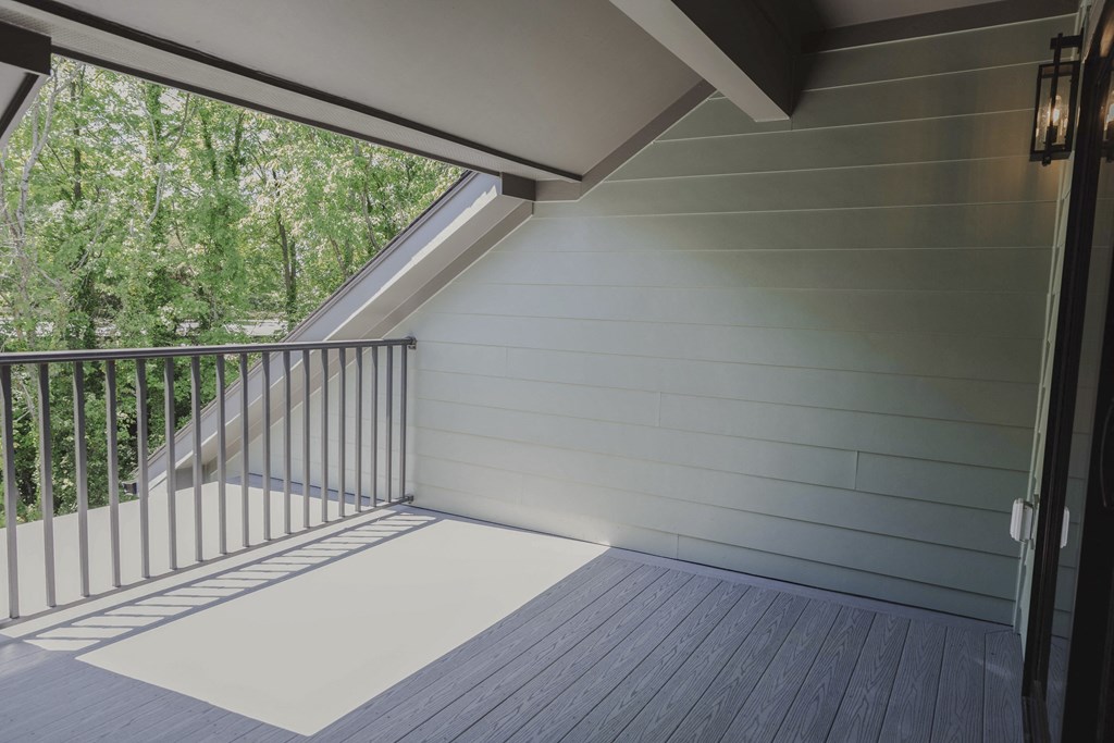 a covered porch with a view of a tree