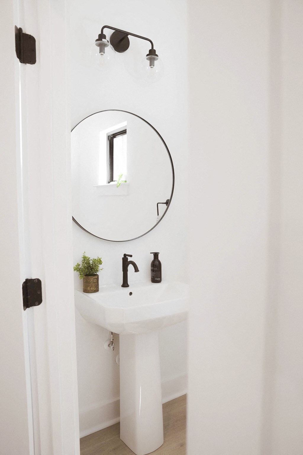 a small bathroom with a sink and a mirror