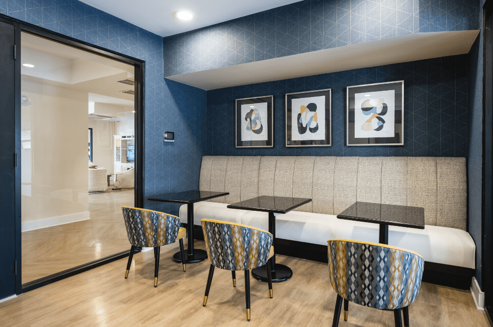 a seating area with tables and chairs in a hotel room at Park View Greer, South Carolina