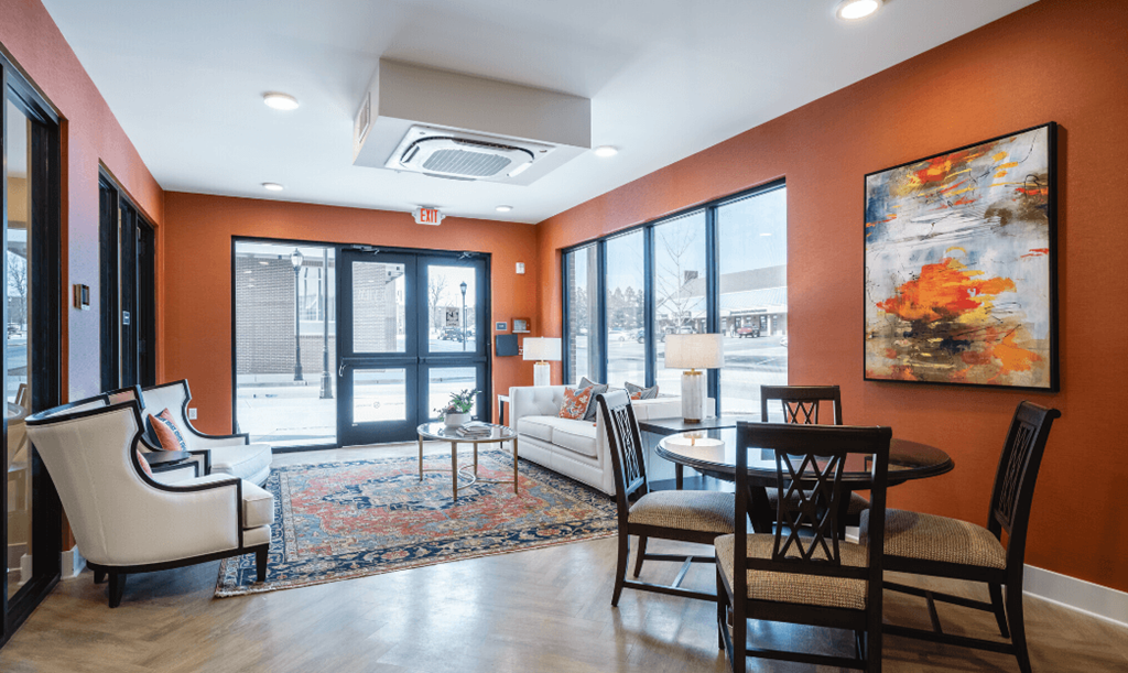 a living room with orange walls and a table and chairs at Park View Greer, Greer, South Carolina