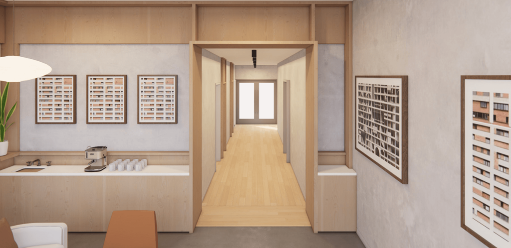 a view down a long hallway with a white counter and chairs and a window at the end