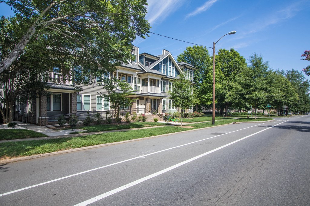 A street with houses on both sides and a clear sky.