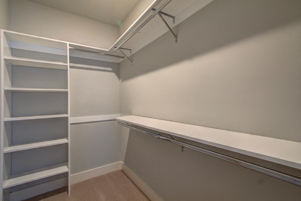 A room with a white shelving unit and a white wall.