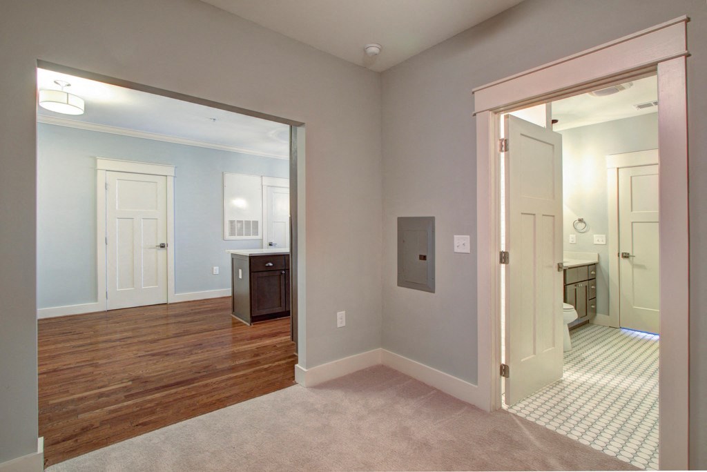 A room with a wooden floor and a white door.