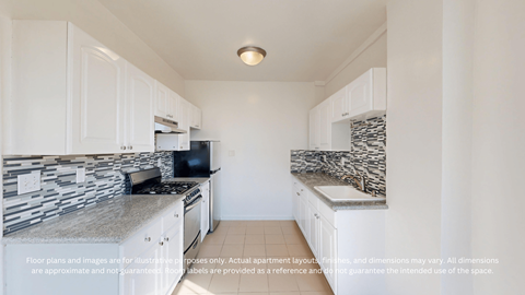 A kitchen with white cabinets and a black and white counter top.