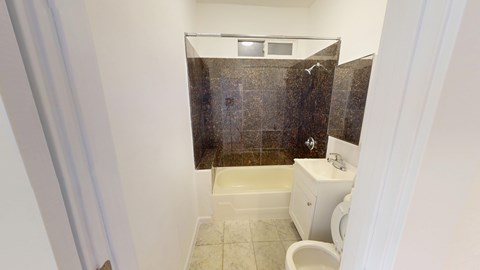 A small bathroom with a toilet and a shower.