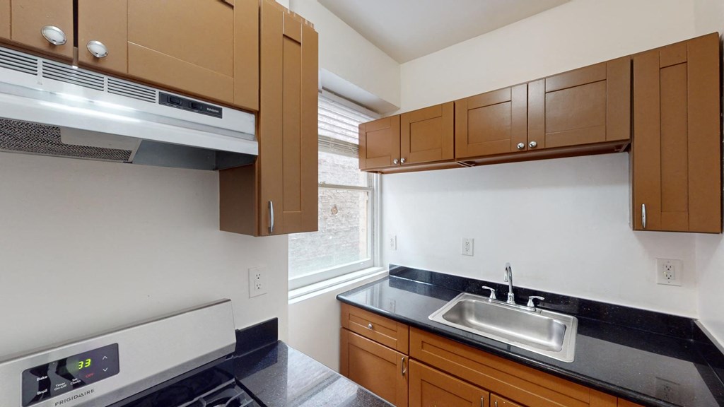 an empty kitchen with a sink and a window