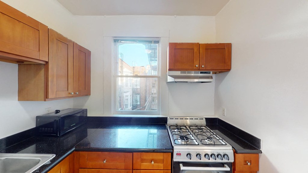 a kitchen with a stove and a window
