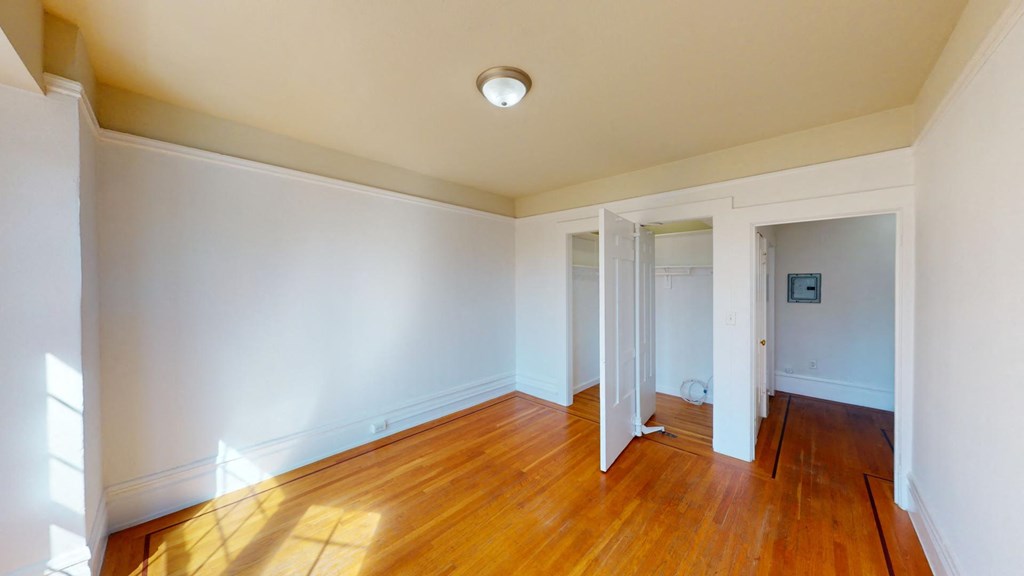 a living room with wood floors and white walls