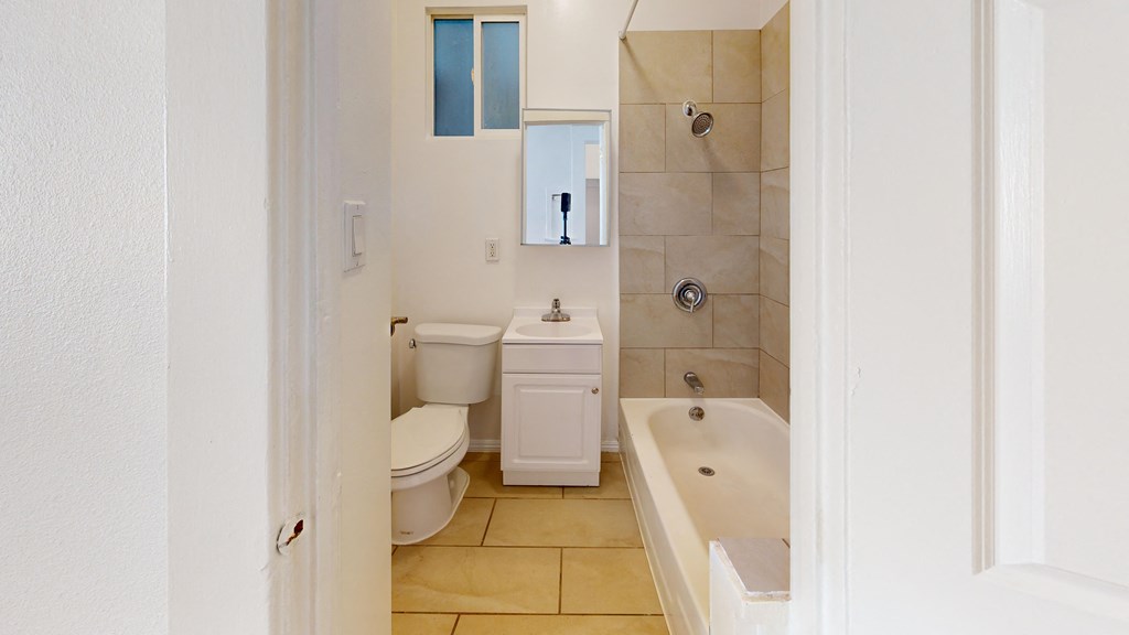 a bathroom with a toilet sink and tub and a shower