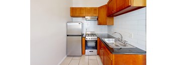 a kitchen with wooden cabinets and stainless steel appliances