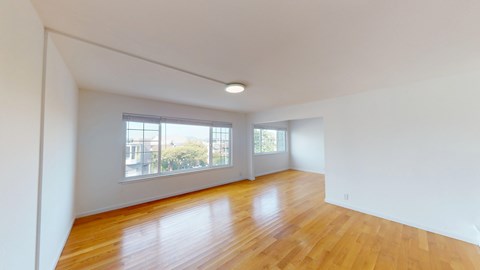 A room with wooden floors and white walls.