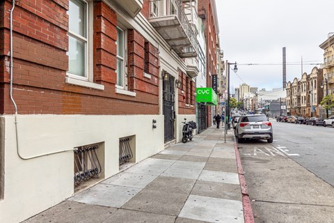 A street view with a car parked on the side of the road.