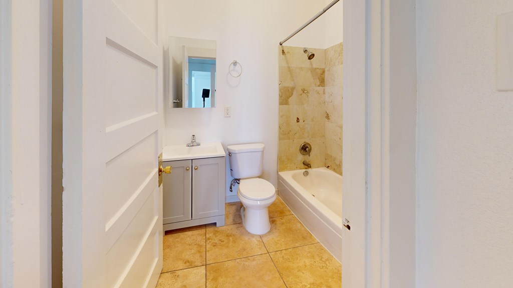 A white toilet and sink in a bathroom.