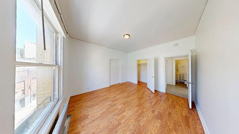 A room with wooden floors and white walls.