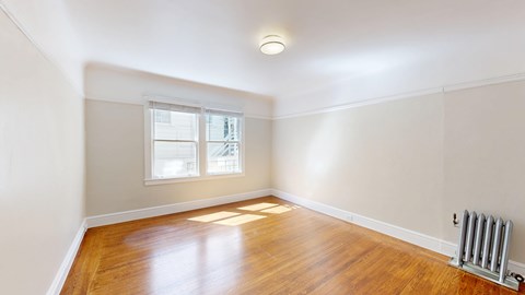 A room with wooden floors and a window.