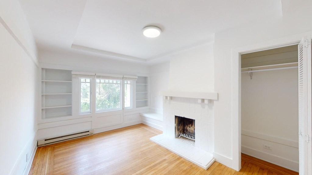 a living room with a fireplace and a window