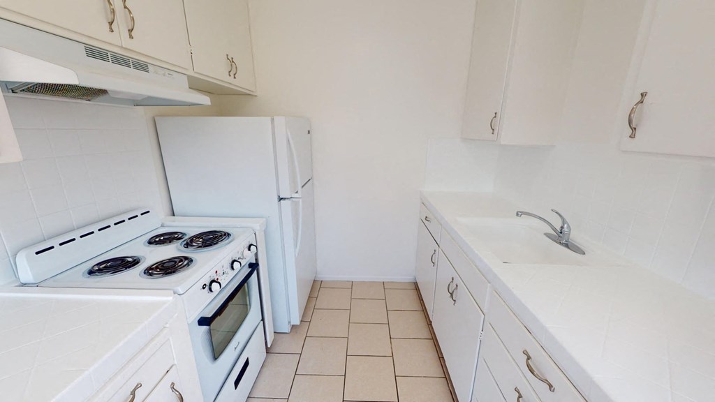a kitchen with a stove and a refrigerator